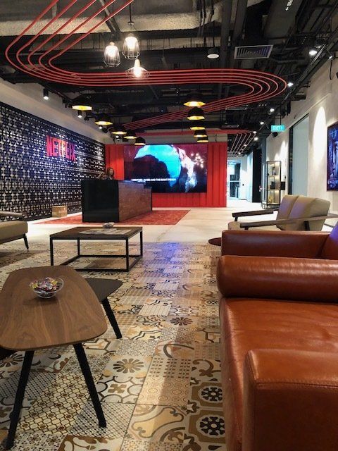 A living room with a couch , table and chairs