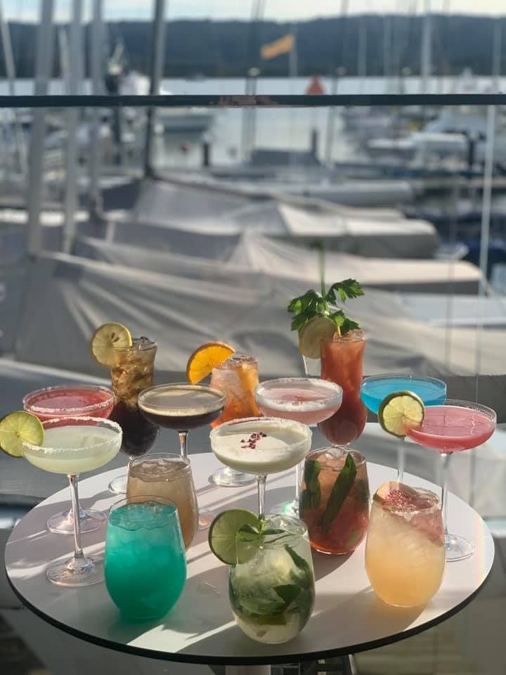 A Table Topped With a Variety of Cocktails With Boats in the Background — Gosford Sailing Club in Gosford, NSW