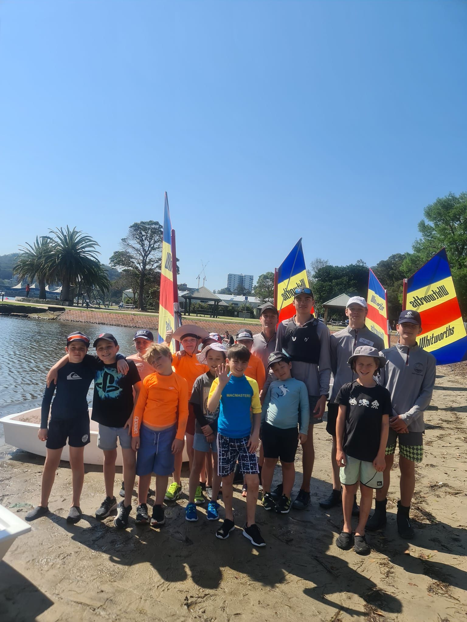 Group of Kids and Adults by a Lake having Sailboat — Gosford Sailing Club in Gosford, NSW