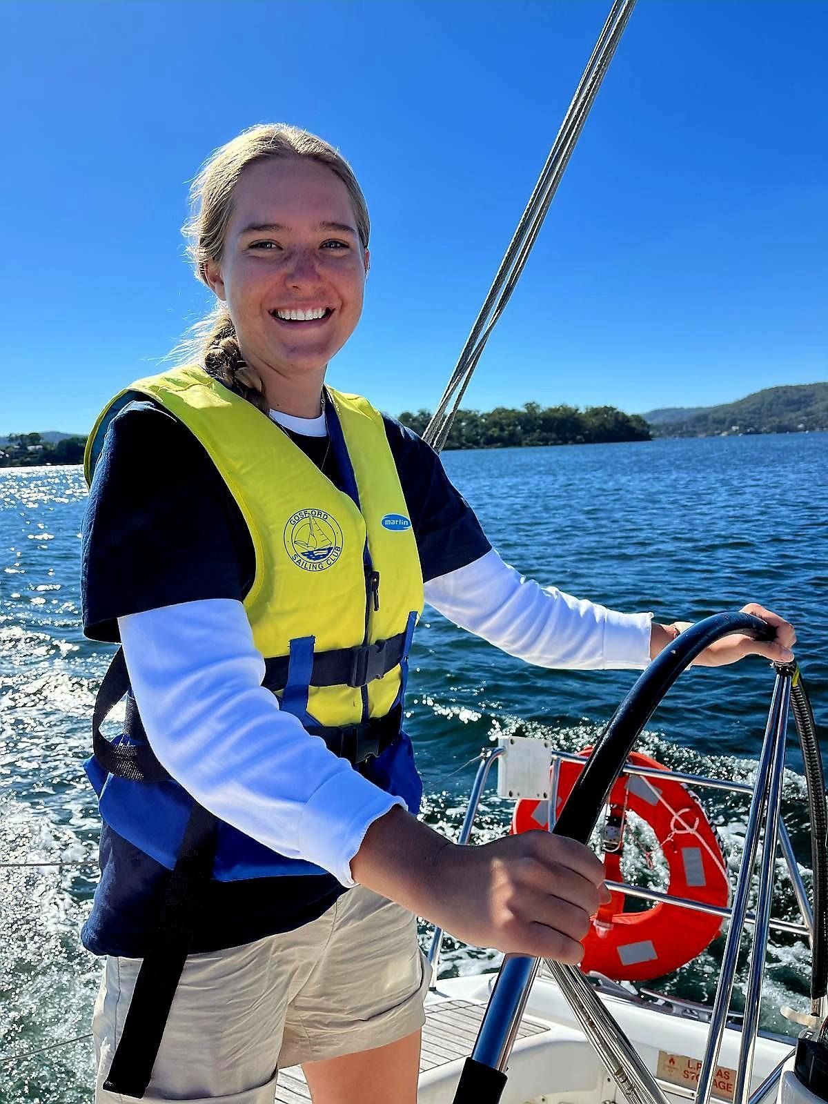 Young Woman Steers a Sailboat — Gosford Sailing Club in Gosford, NSW
