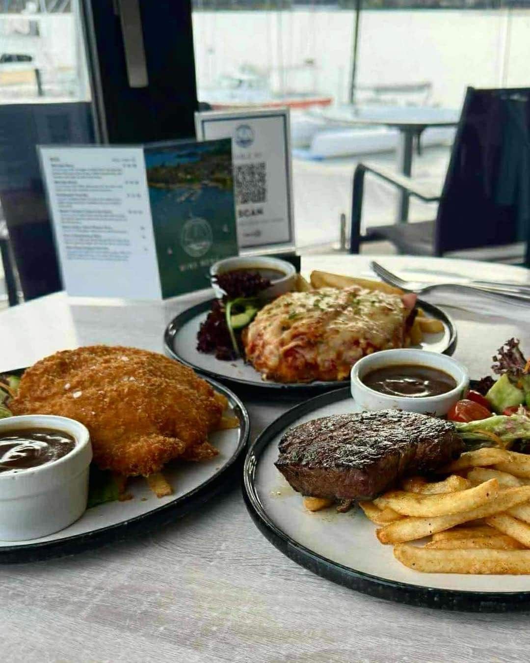 Two Plates of Food Are Sitting on a Table — Gosford Sailing Club in Gosford, NSW