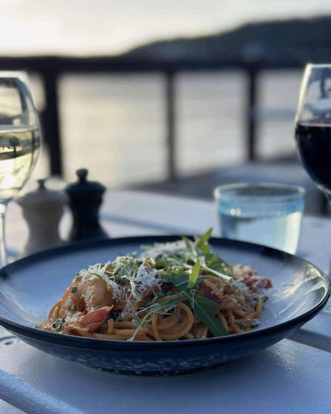 A Plate of Spaghetti With Shrimp and a Glass of Wine on a Table — Gosford Sailing Club in Gosford, NSW