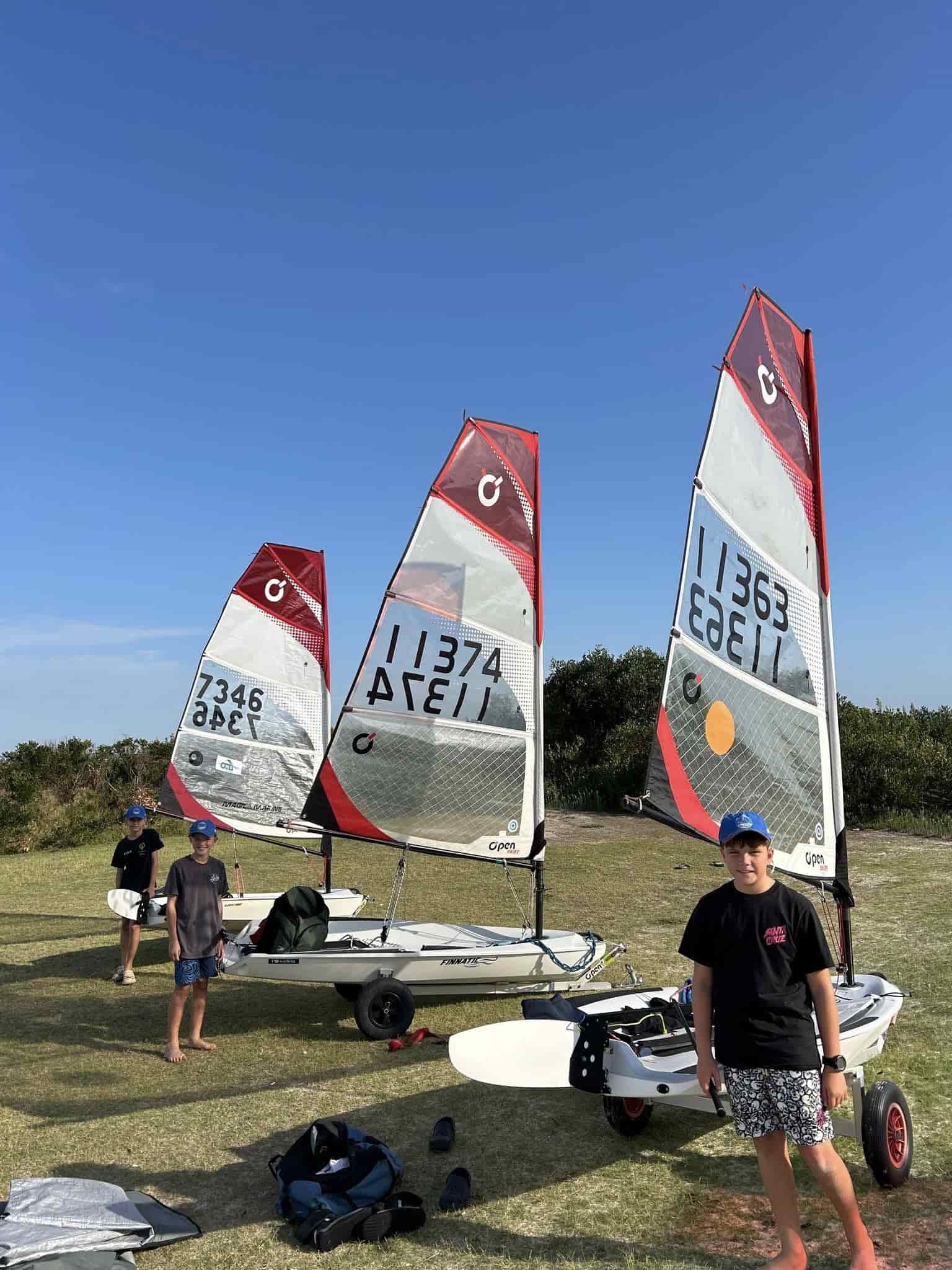A Man is Standing in Front of Three Sailboats in a Field — Gosford Sailing Club in Gosford, NSW