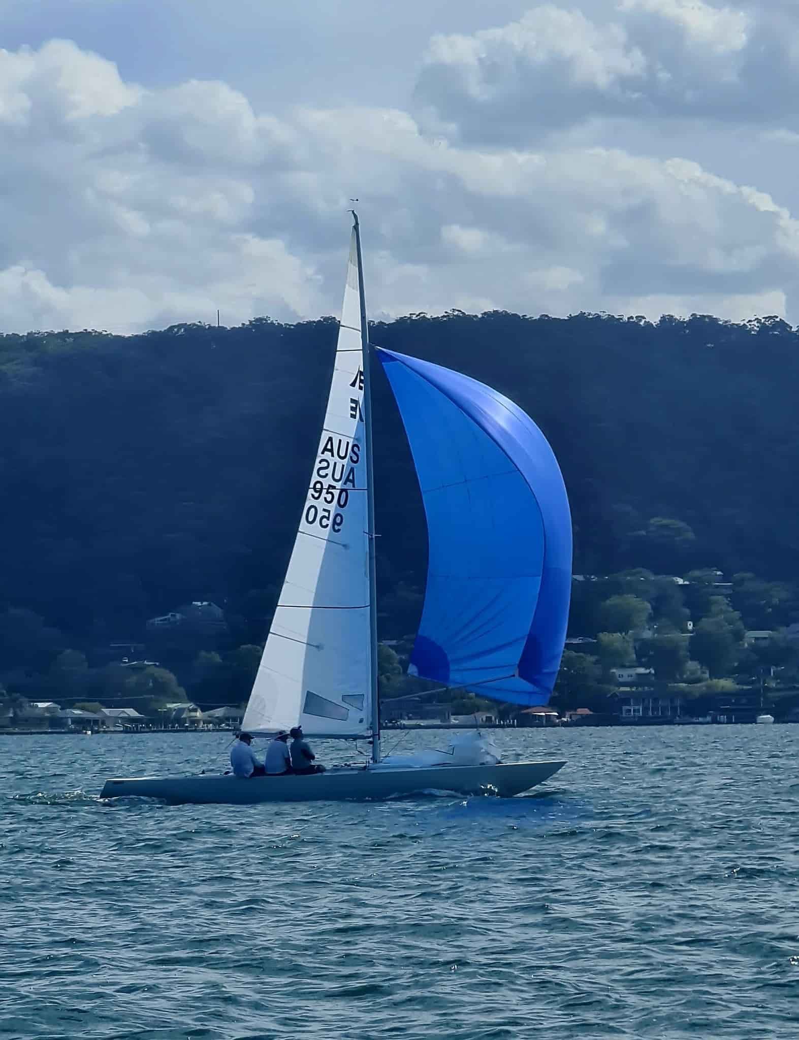 A Sailboat With a Blue Sail is in the Water — Gosford Sailing Club in Gosford, NSW