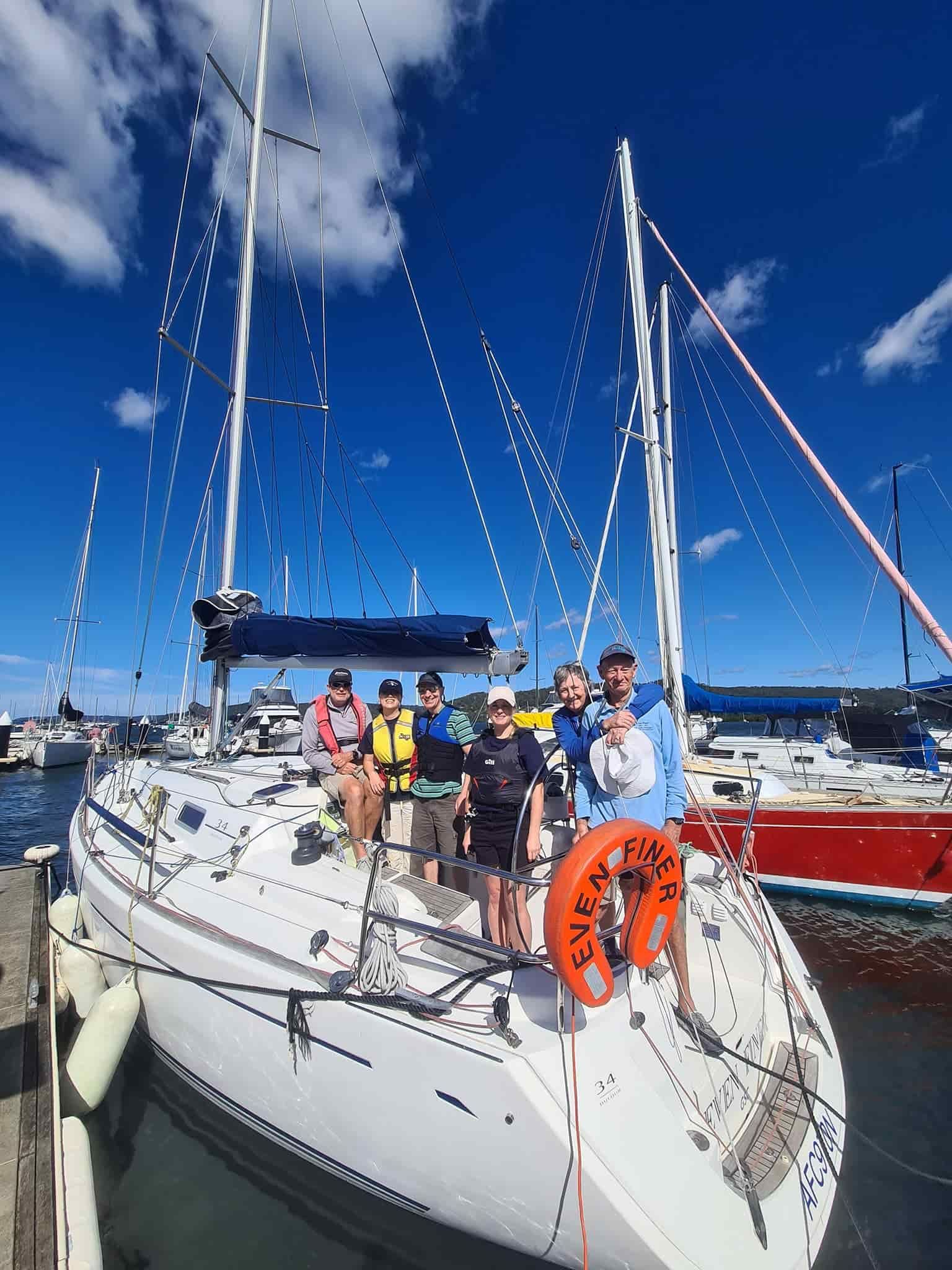 A Group of People Are Standing on the Deck of a Sailboat — Gosford Sailing Club in Gosford, NSW