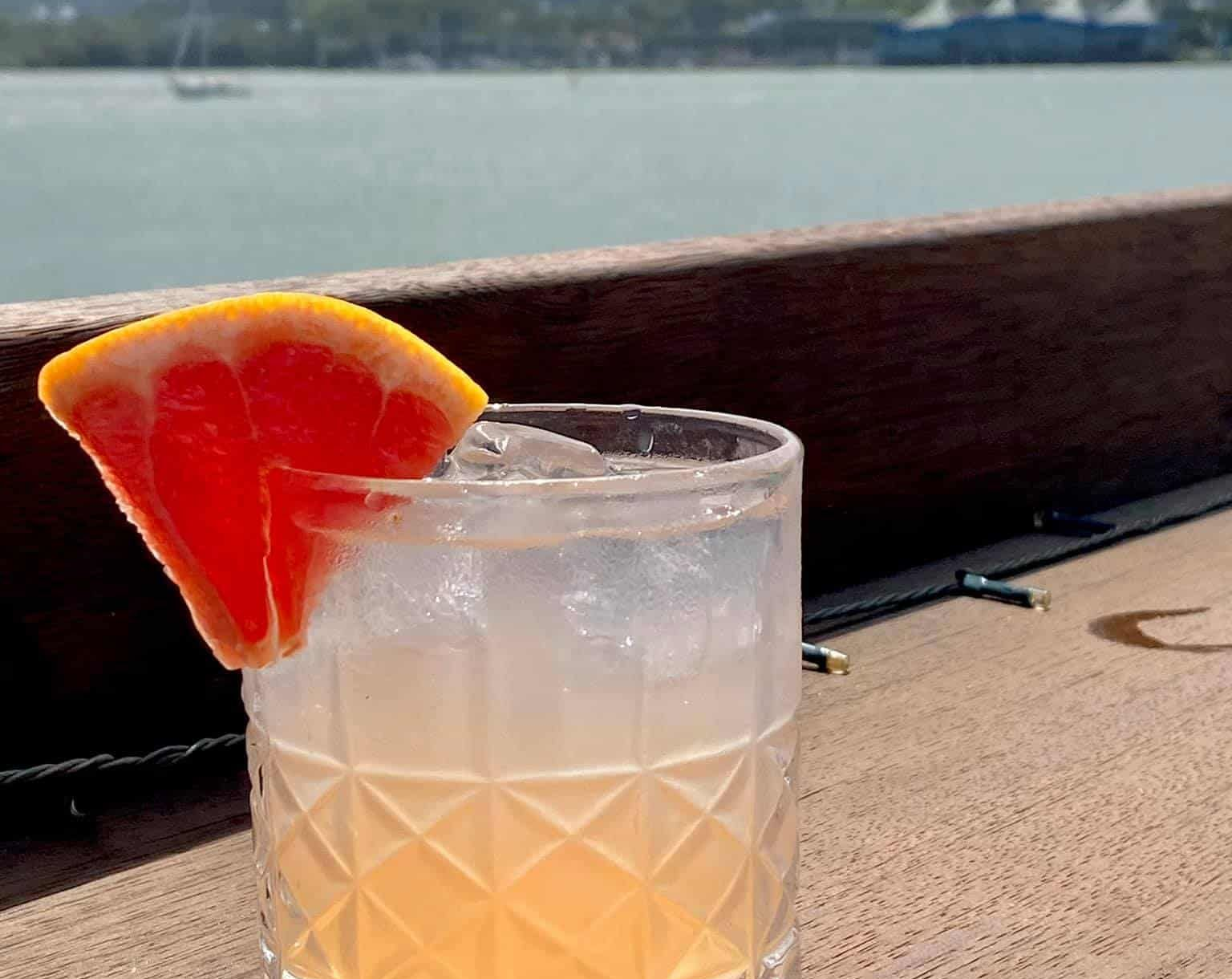 People Sharing a Meal at a Wooden Table — Gosford Sailing Club in Gosford, NSW