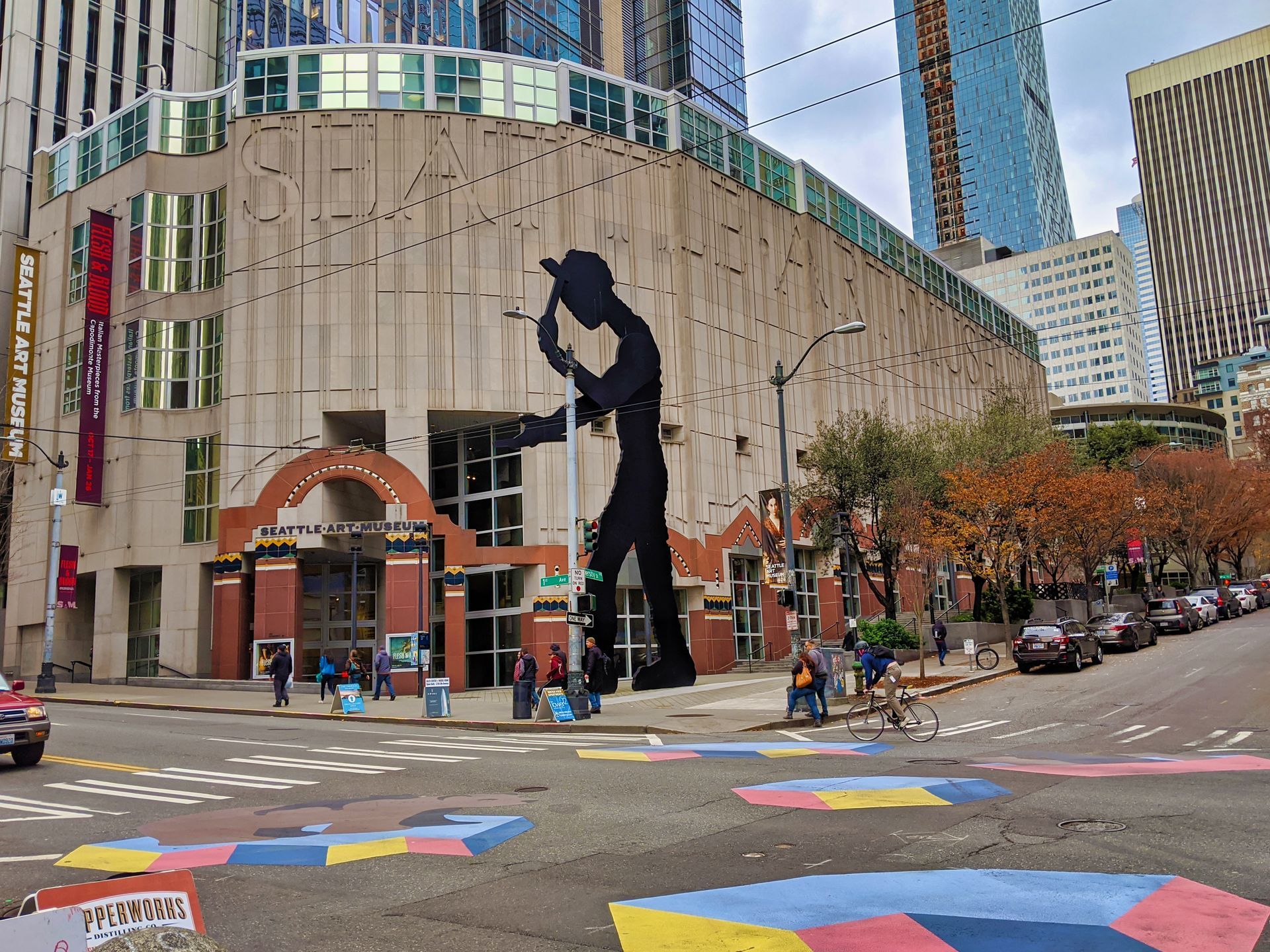 A giant silhouette of a man is painted on the side of a building