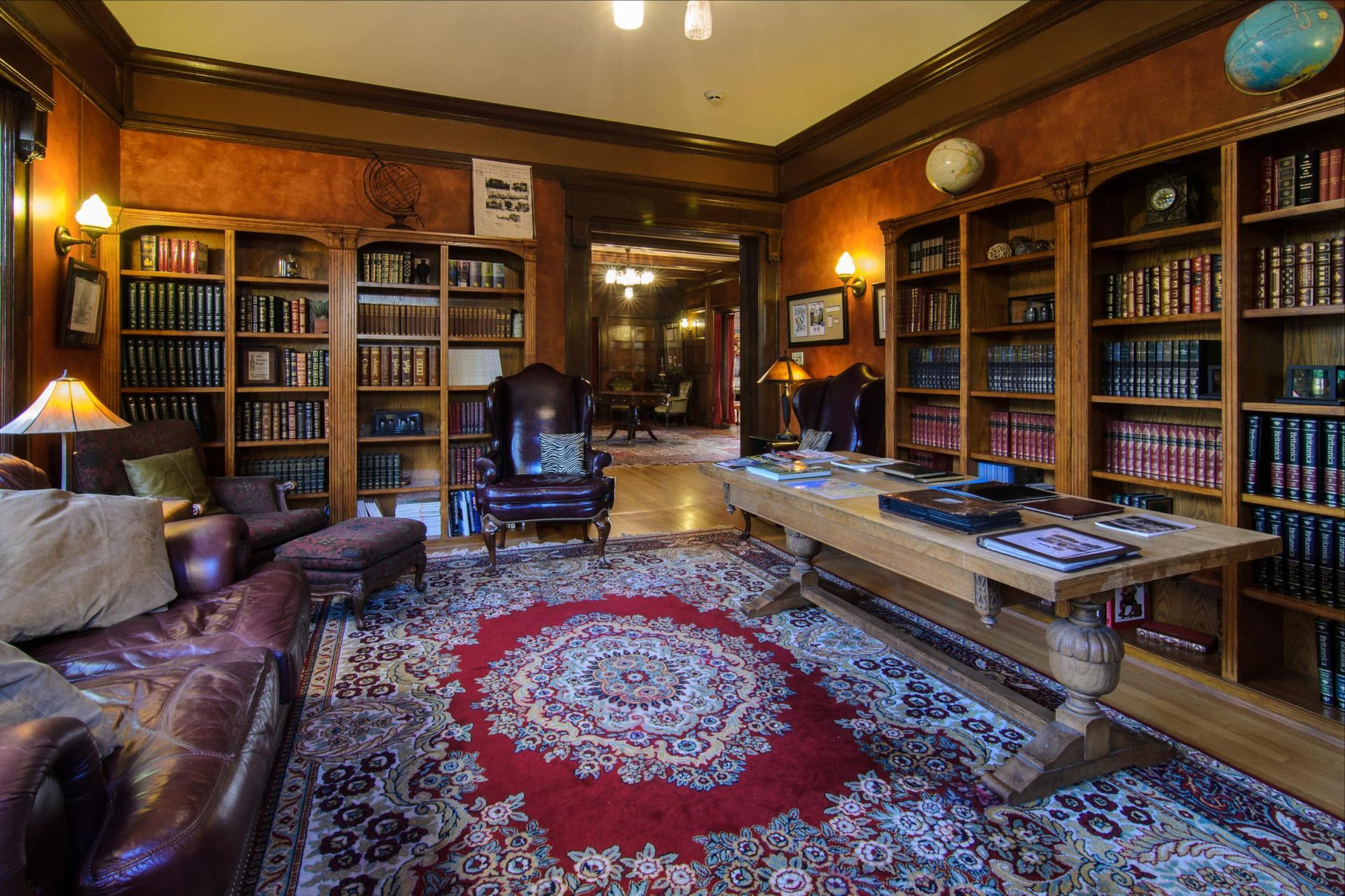 A living room filled with furniture and bookshelves.