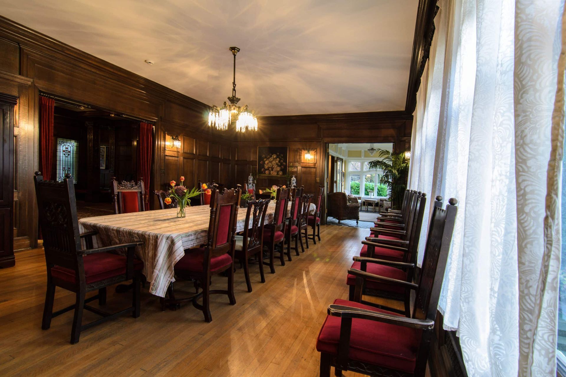 A large dining room with a long table and chairs.