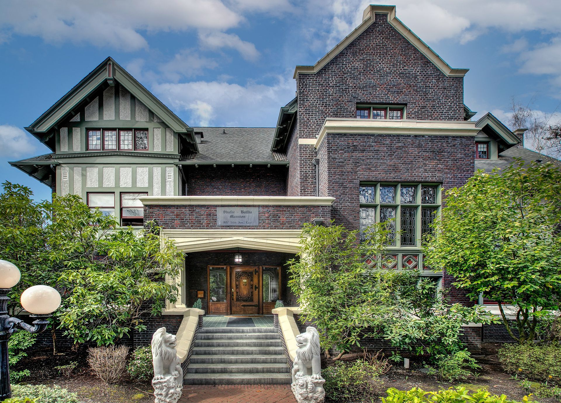 A large brick house with stairs leading up to it