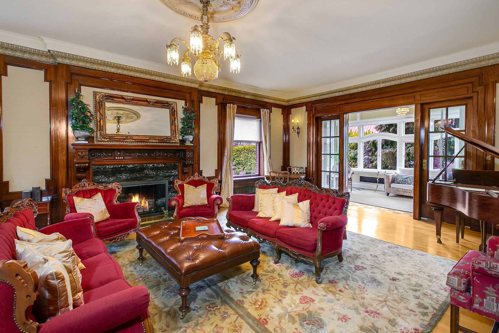 A living room with red furniture and a fireplace