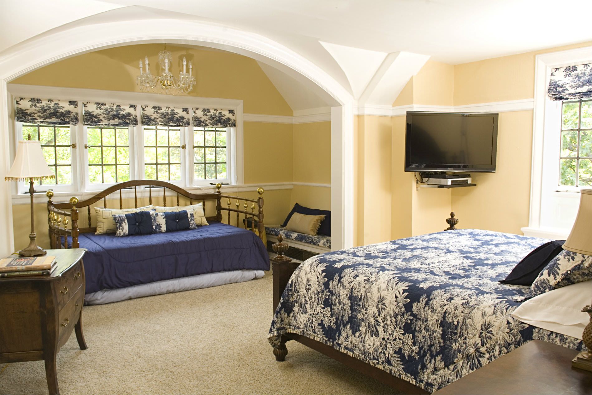 A bedroom with a large bed and a flat screen tv