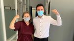 A man and a woman wearing face masks are posing for a picture.