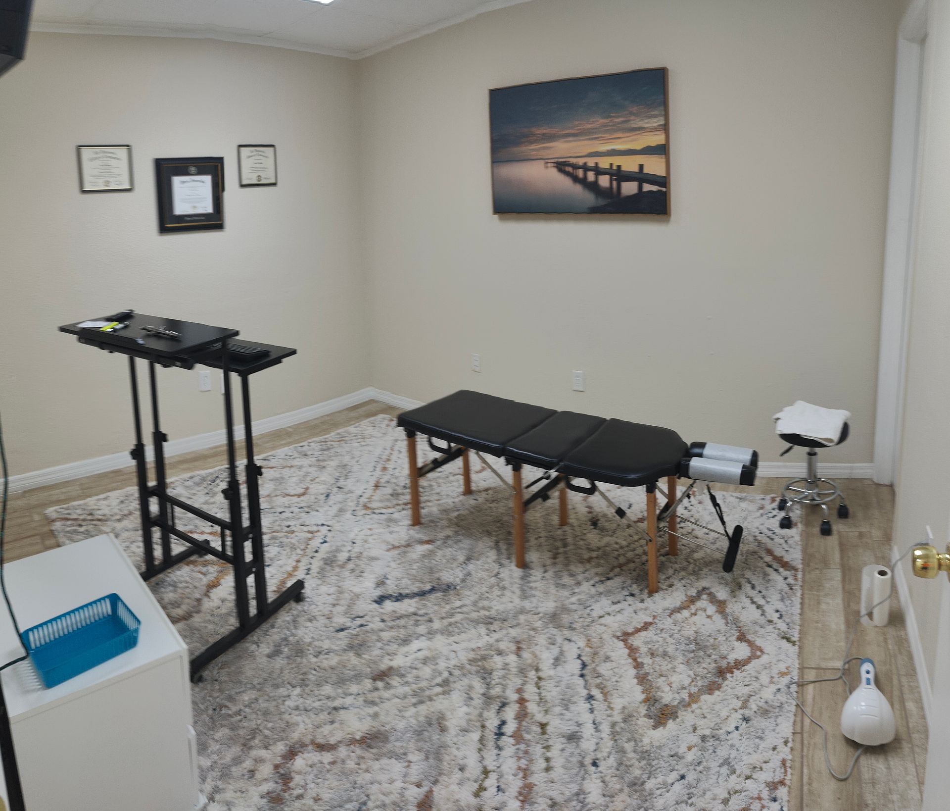 A room with a table and a painting on the wall