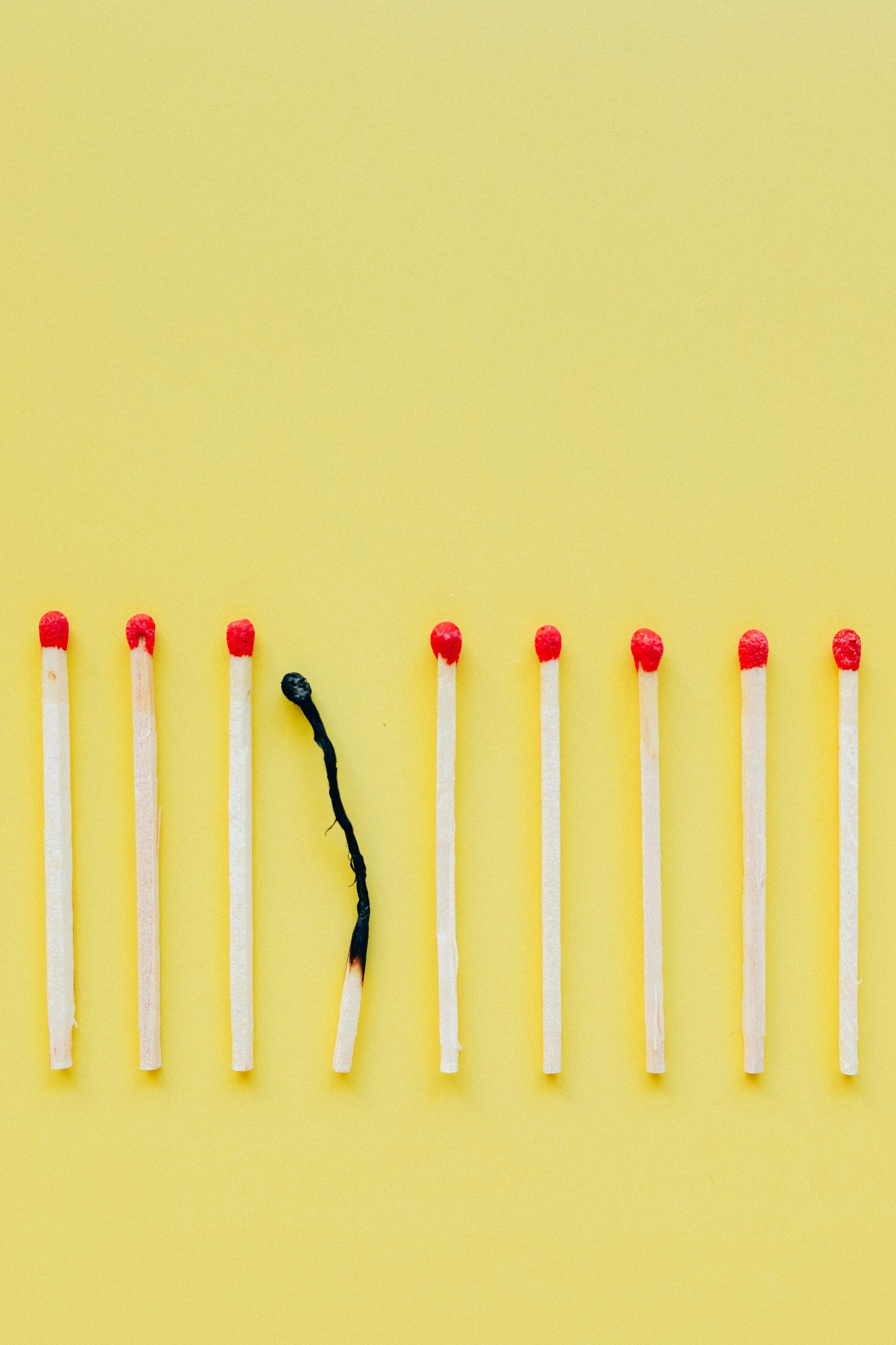 A  row of matches with one burned out.