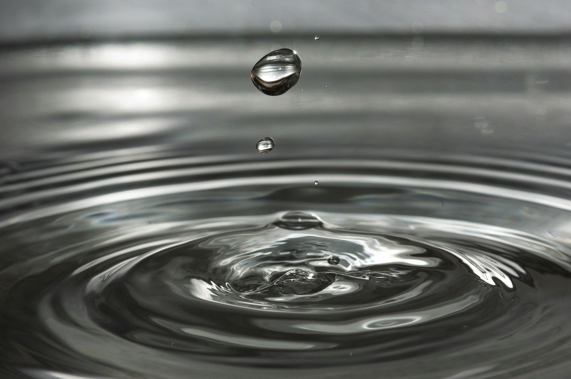A water droplet splashing into a puddle