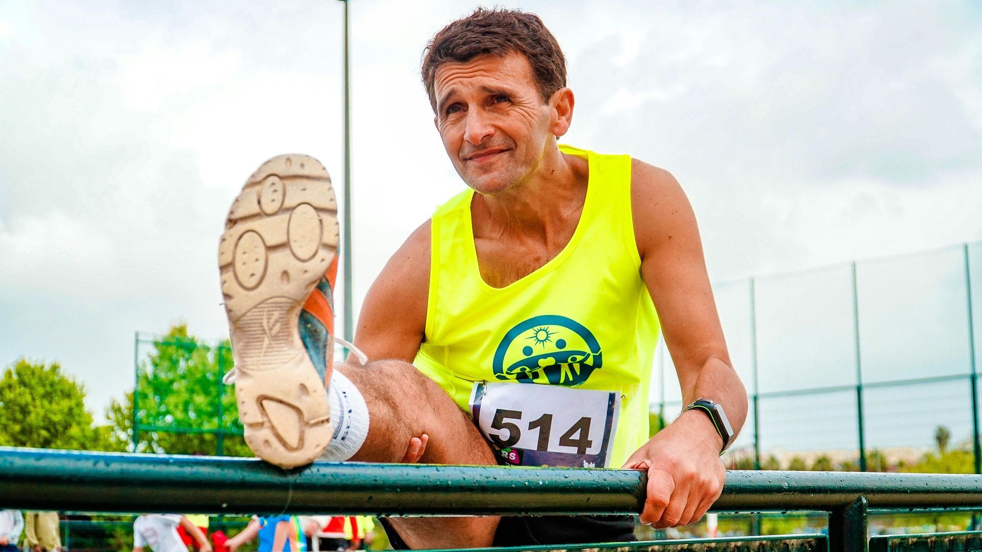 A runner stretching his leg.