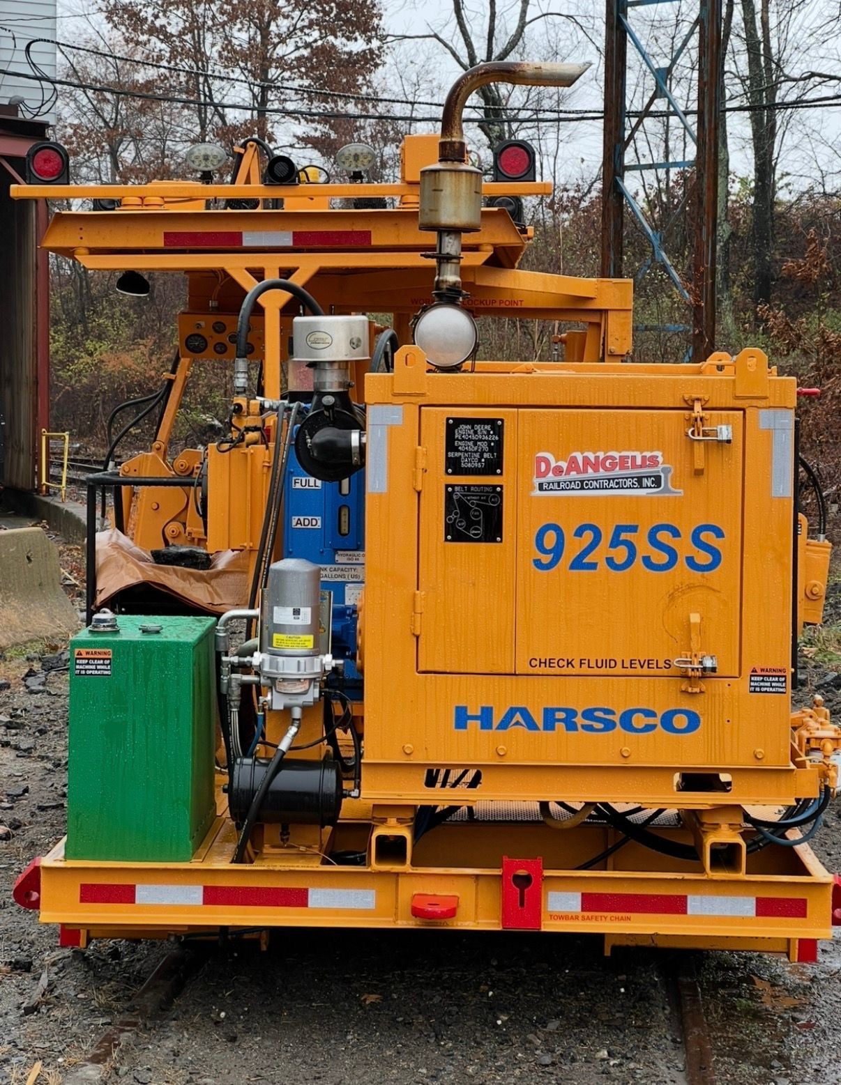Orange Harsco 925SS industrial machine mounted on a trailer outdoors in a wooded area