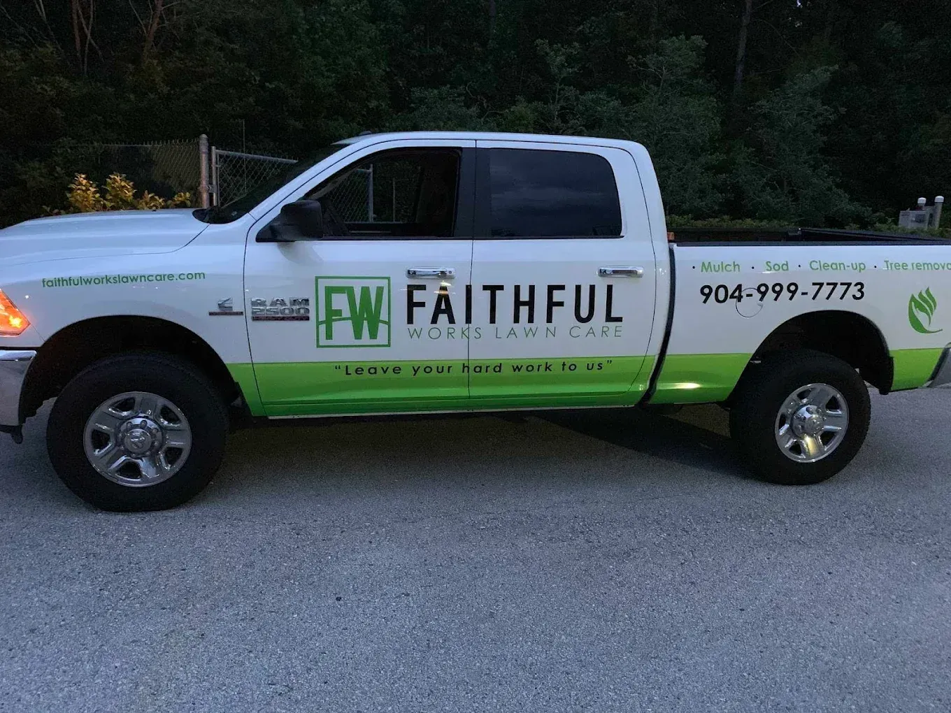 A white faithful truck is parked on the side of the road