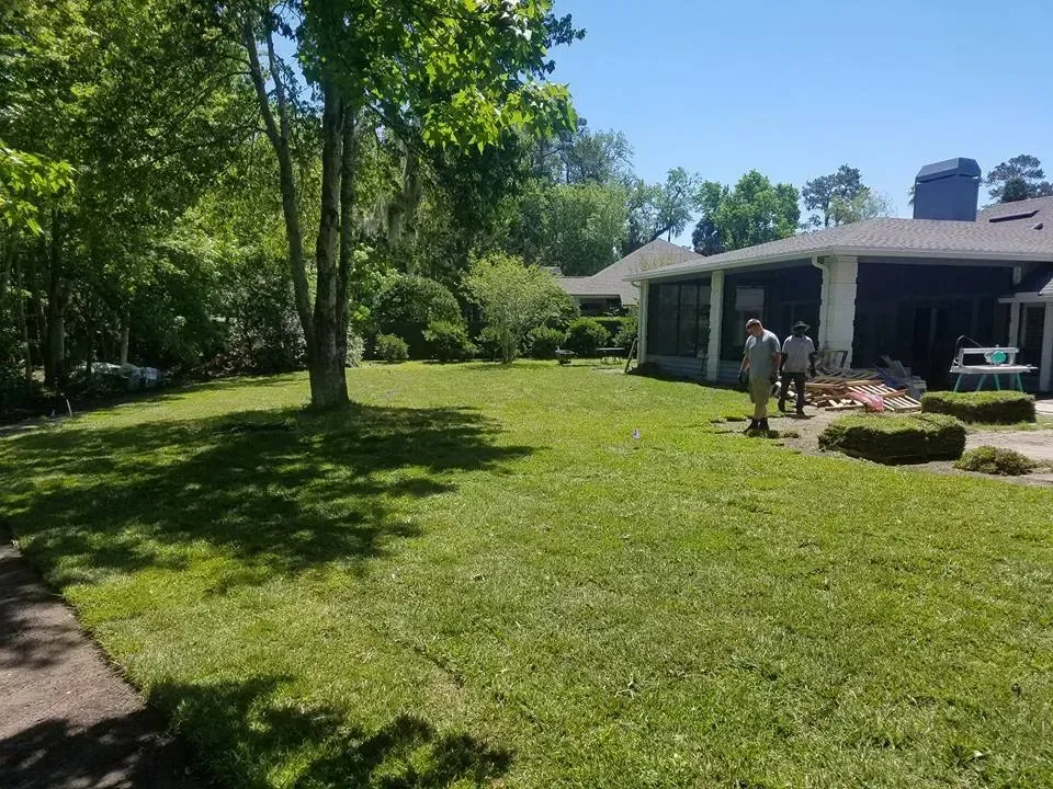 A large lush green lawn in front of a house.