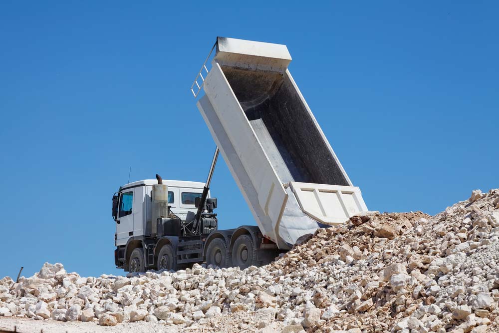 Tipper Truck Unloads Rocks — Tipper Truck Hire In Port Macquarie, NSW
