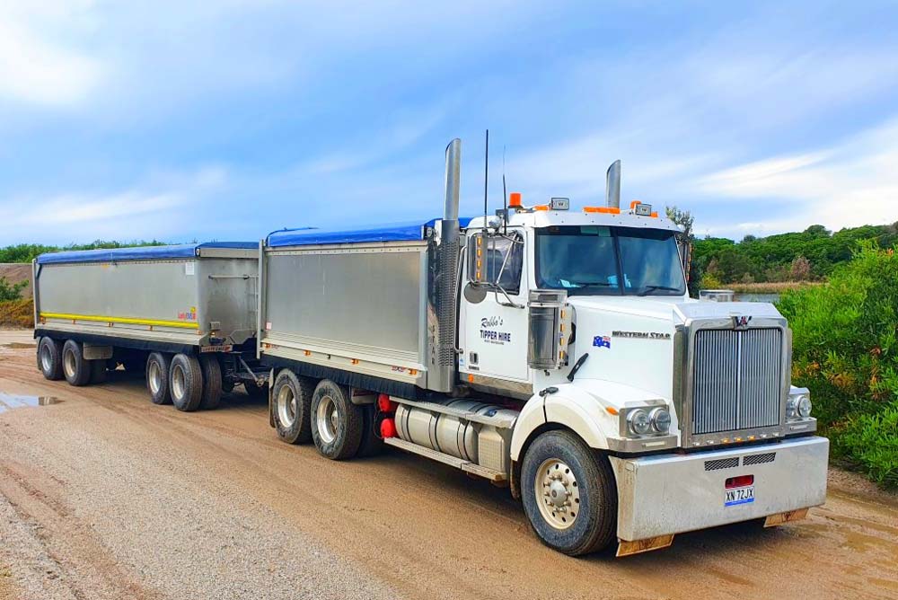 White Tipper Truck Carrying Heavy Load — Tipper Truck Hire In Port Macquarie, NSW