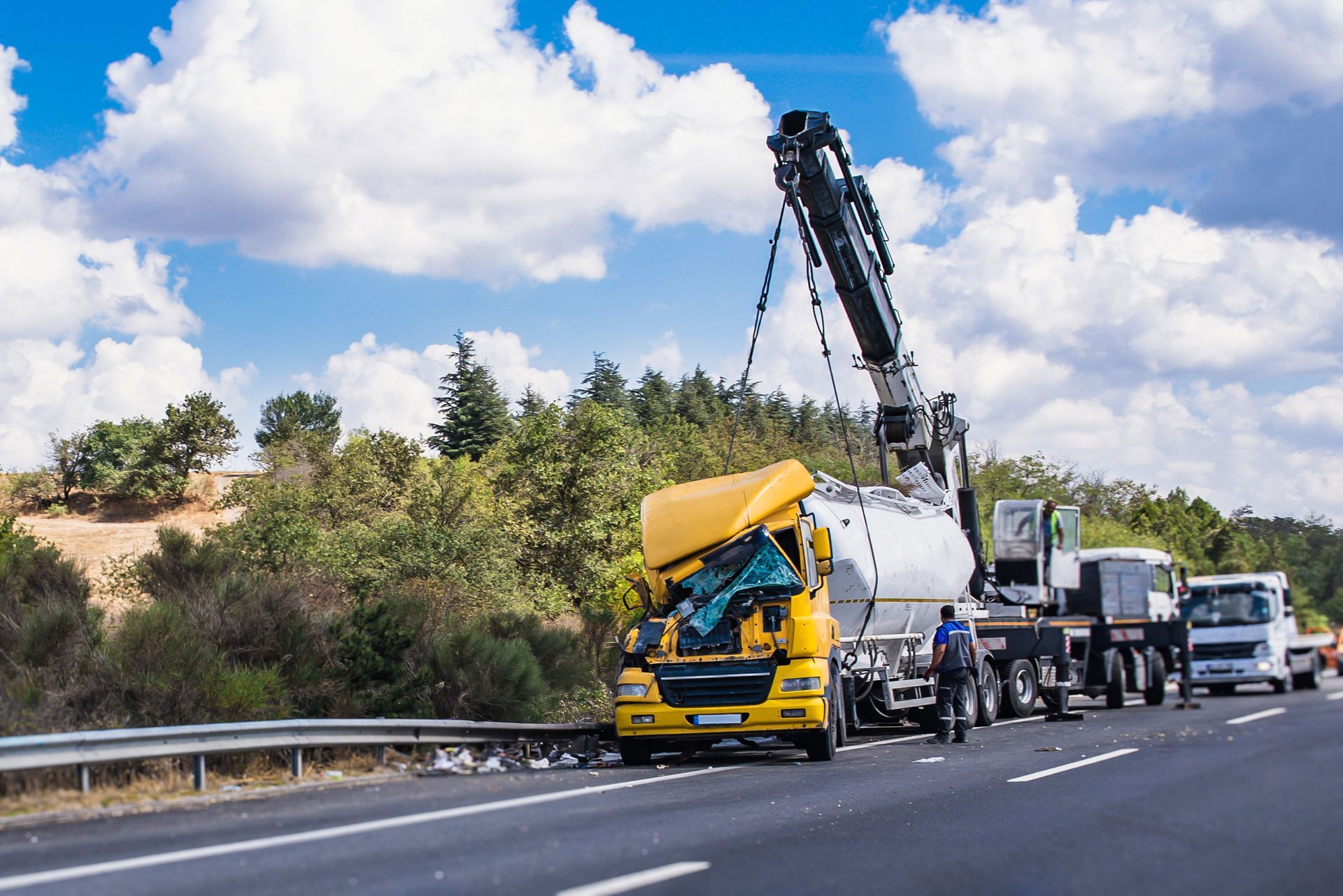 A recovery of a crashed yellow truck with a crane for heavy-duty vehicle accident recovery towing. A recovery of a crashed yellow truck with a crane for heavy-duty vehicle accident recovery towing.