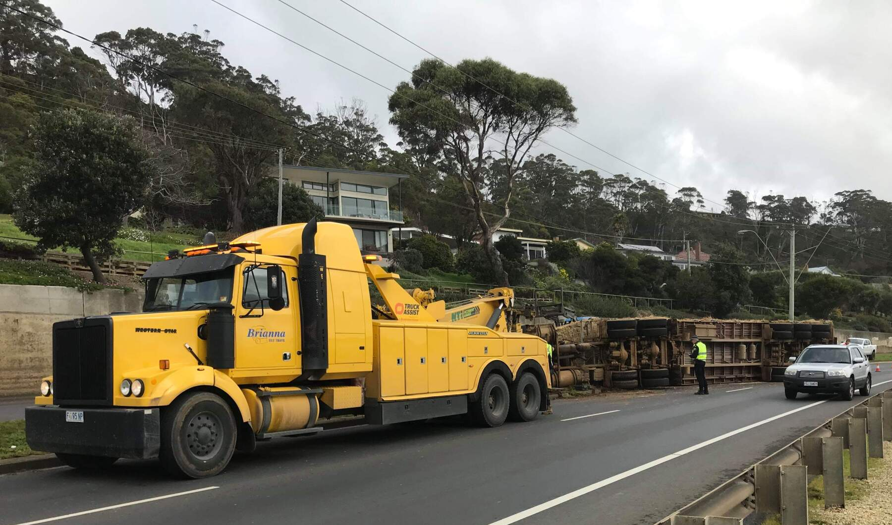 Brianna's 24/7 recovery tow truck assisting log trailer accident.