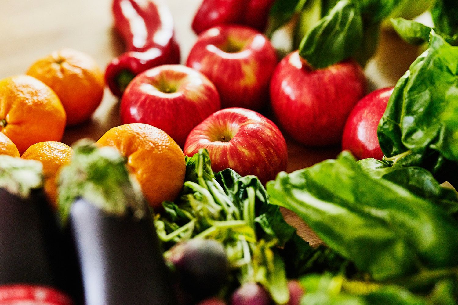 There are many different types of fruits and vegetables on the table.
