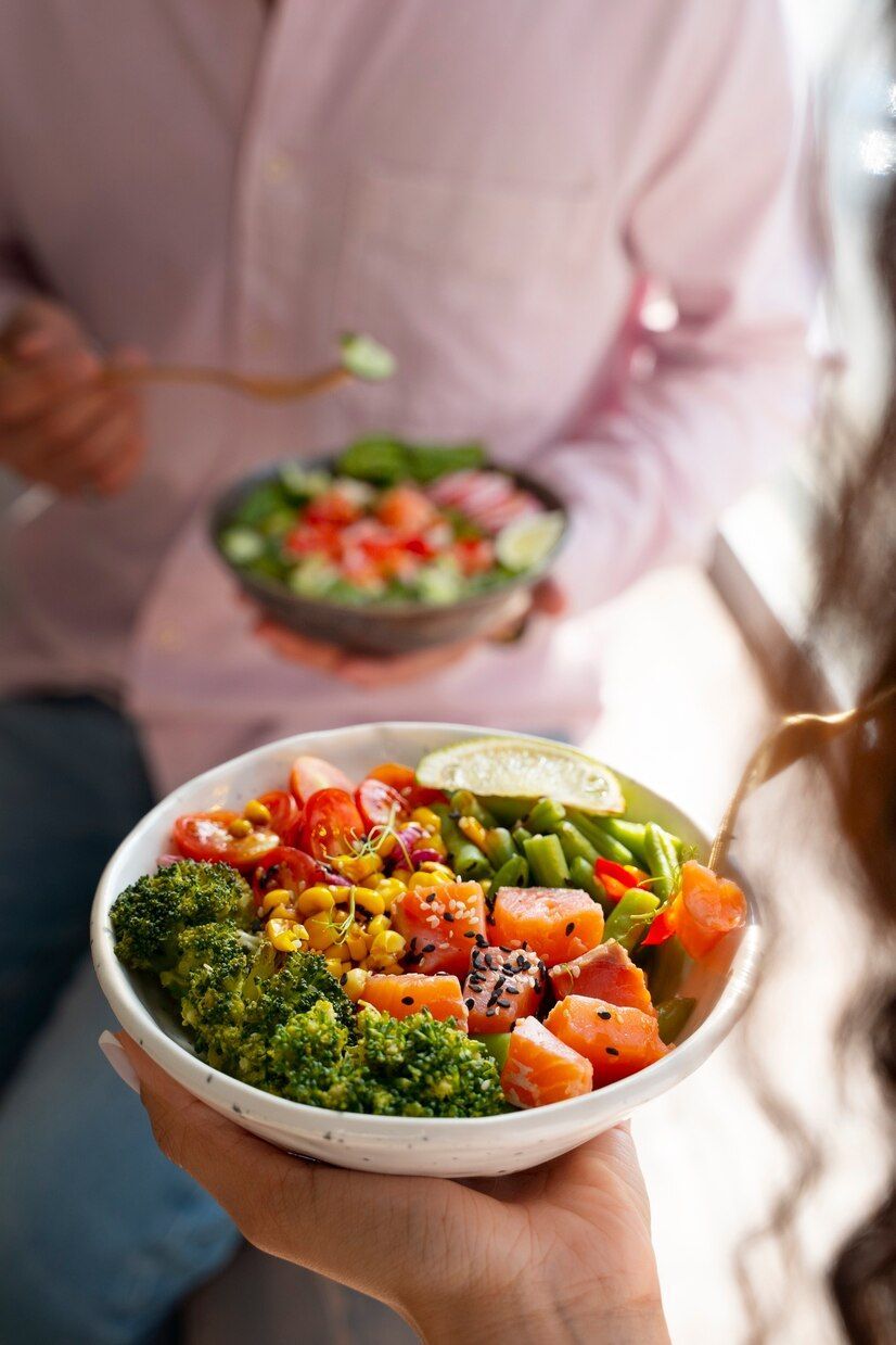 A person is holding a bowl of food in their hand.