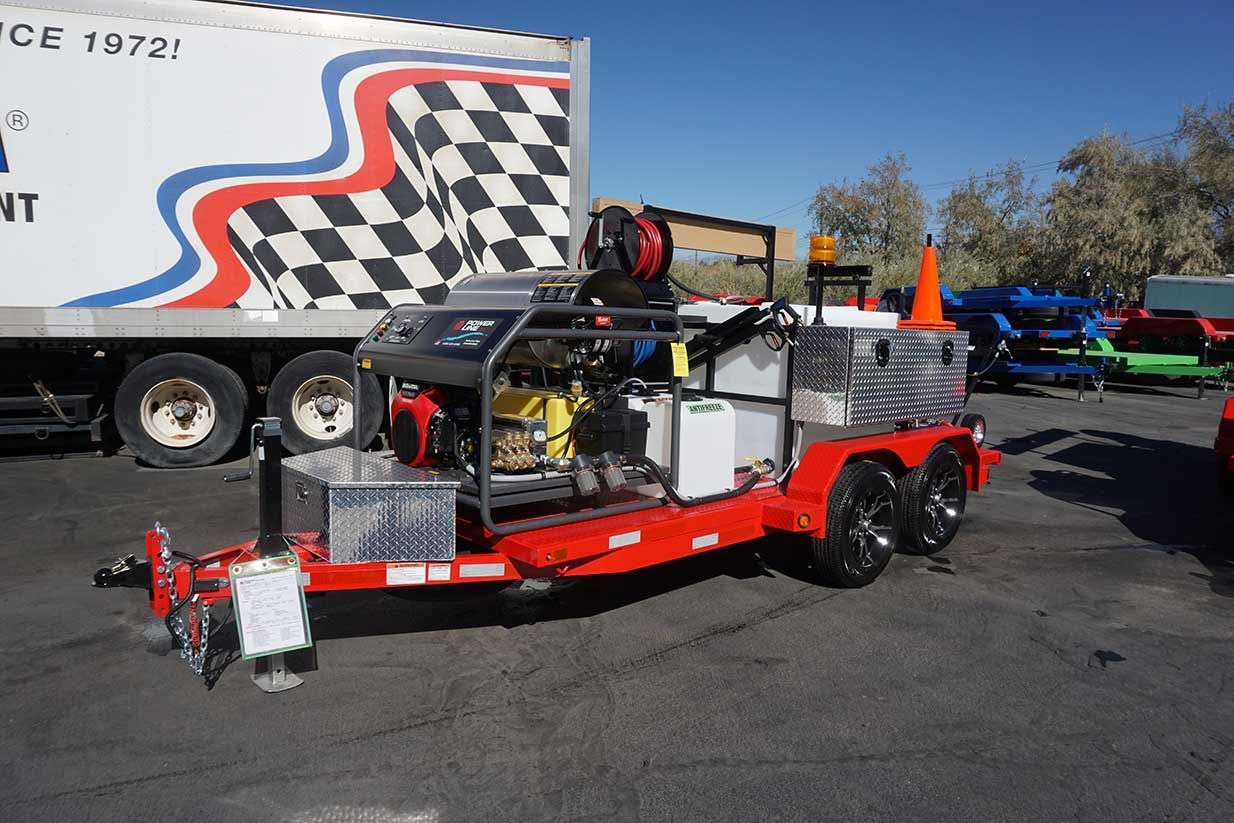 A red Home Shine trailer is parked in front of a white truck with a checkered flag on it.