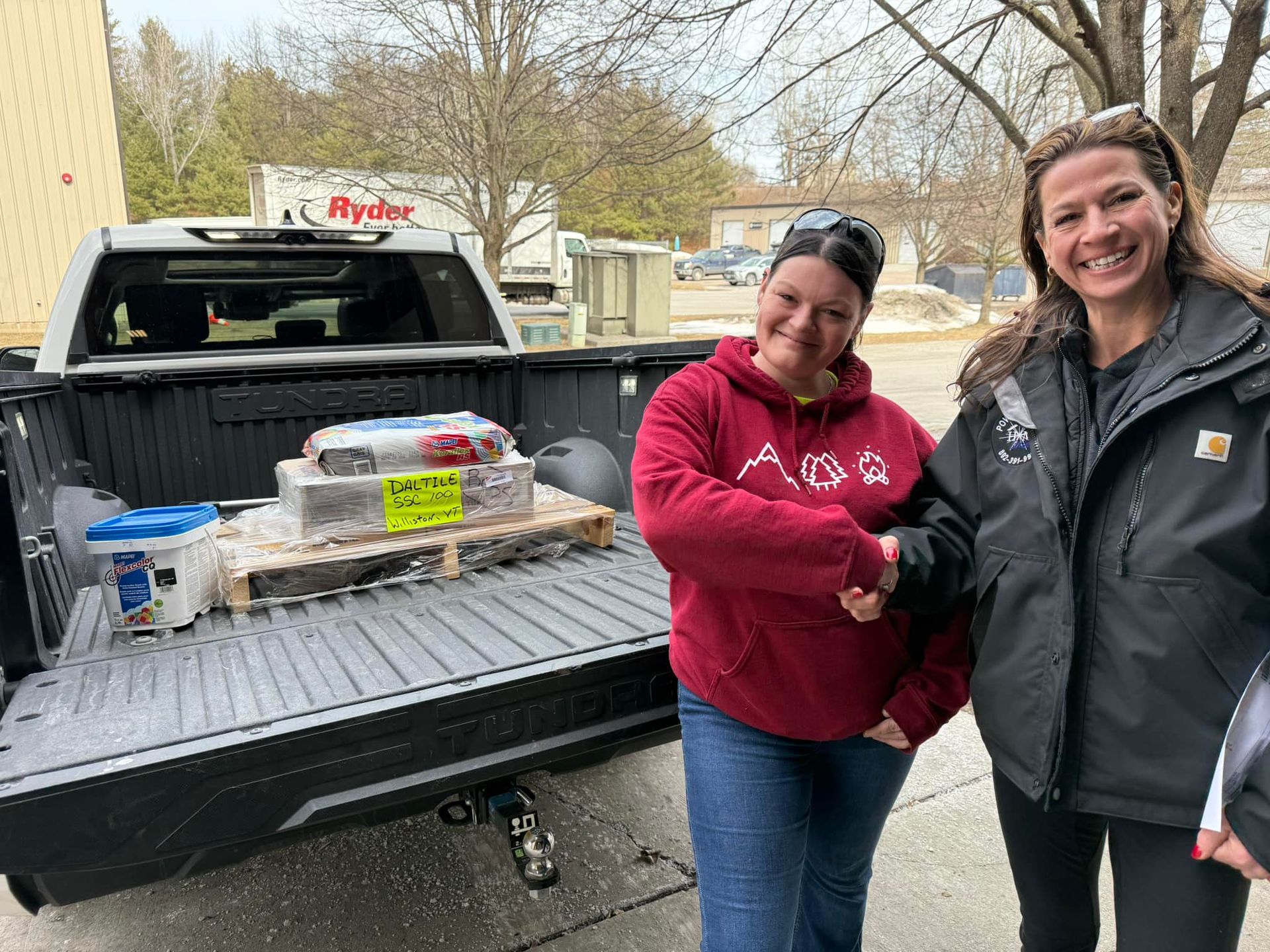 Two Home Shine Employee are shaking hands in front of a truck.