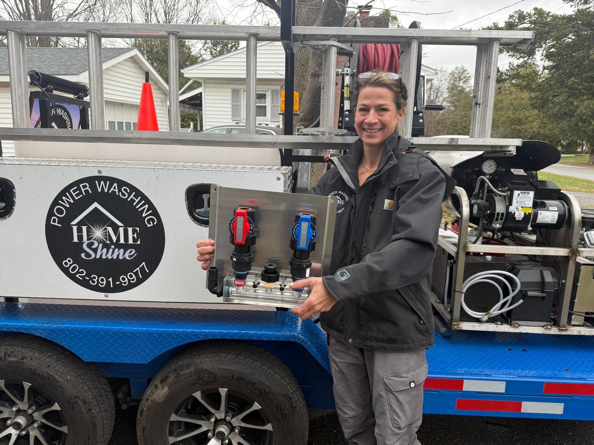 A Home Shine Employee is standing in front of a trailer that says home shine.