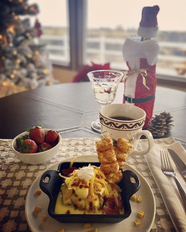 A table with a plate of food and a cup of coffee.