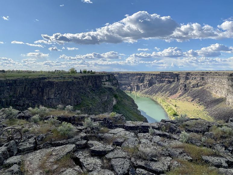A river runs through a canyon between two rocky cliffs.
