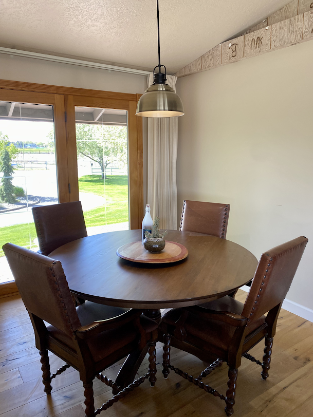 A dining room with a round table and four chairs