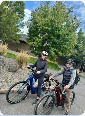 A white plate topped with spaghetti and meatballs with a fork.