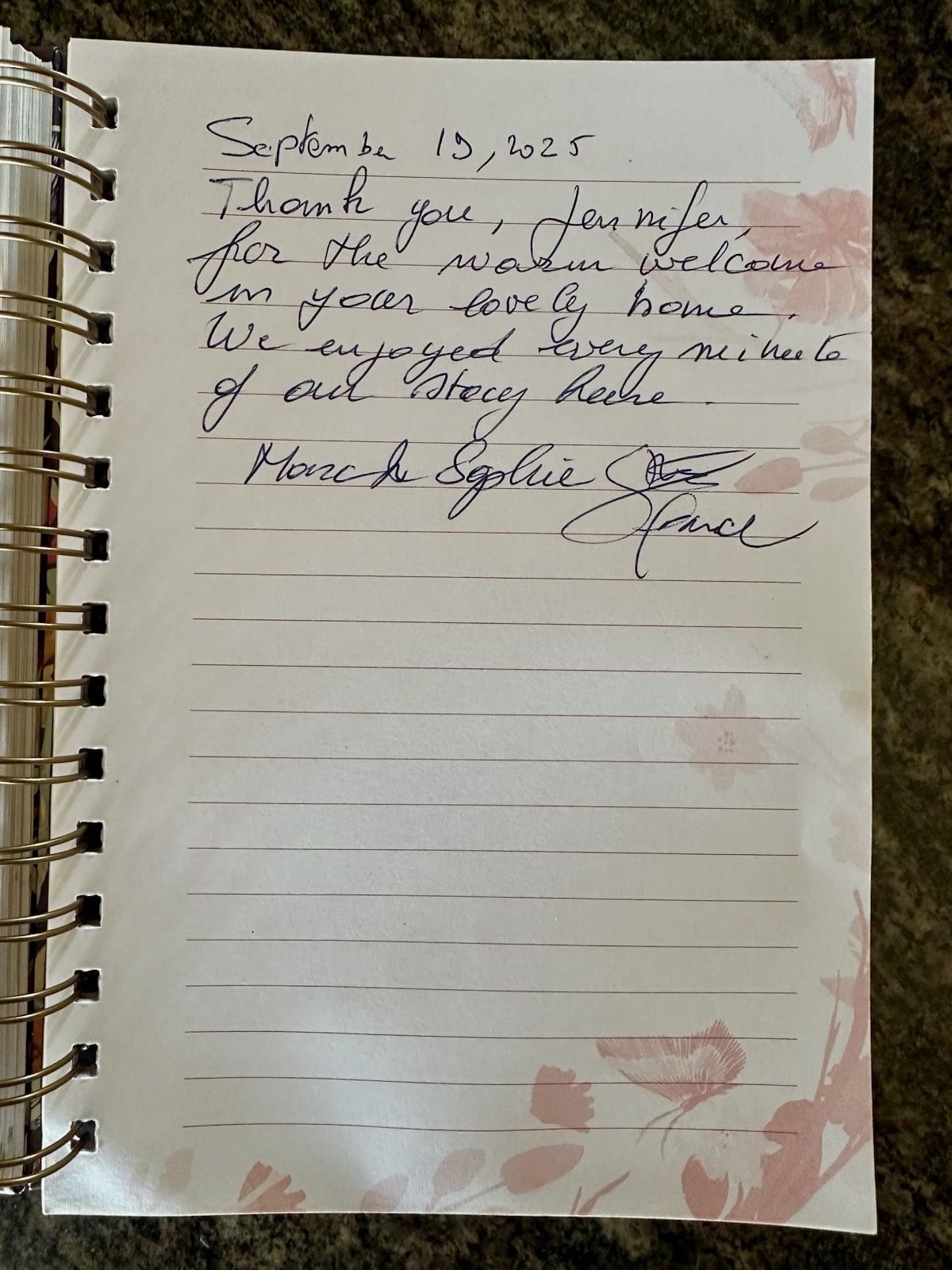 Handwritten note in a floral-bordered notebook: Thank you for a warm welcome.