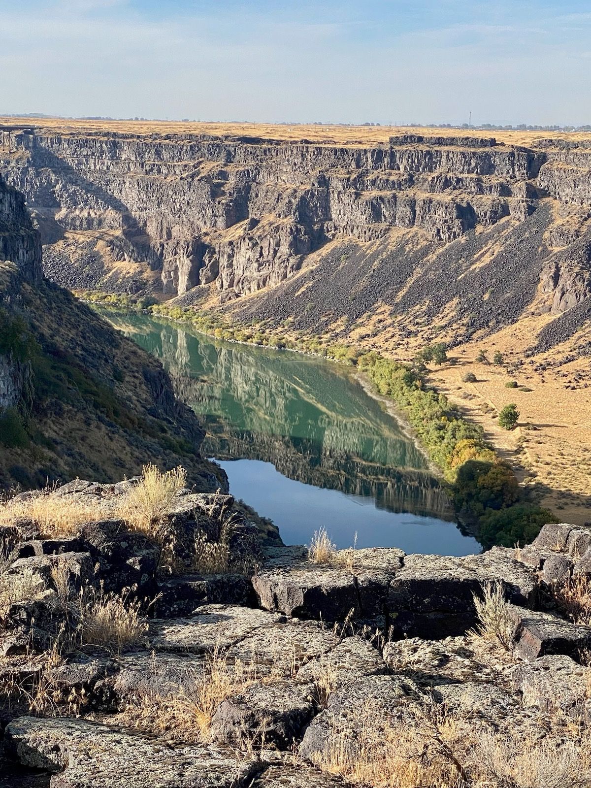 There is a river in the middle of a canyon.