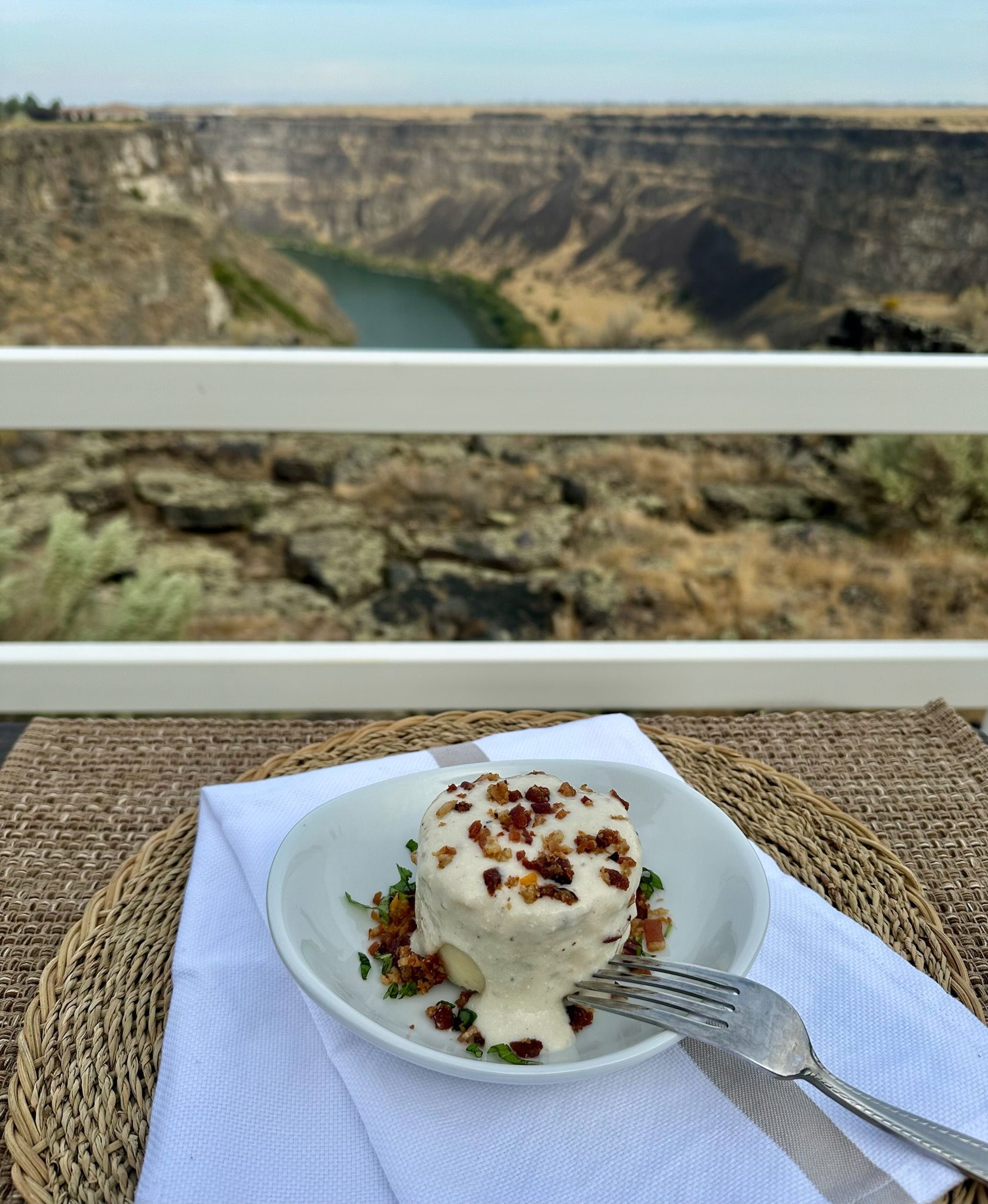 A white plate topped with spaghetti and meatballs with a fork.
