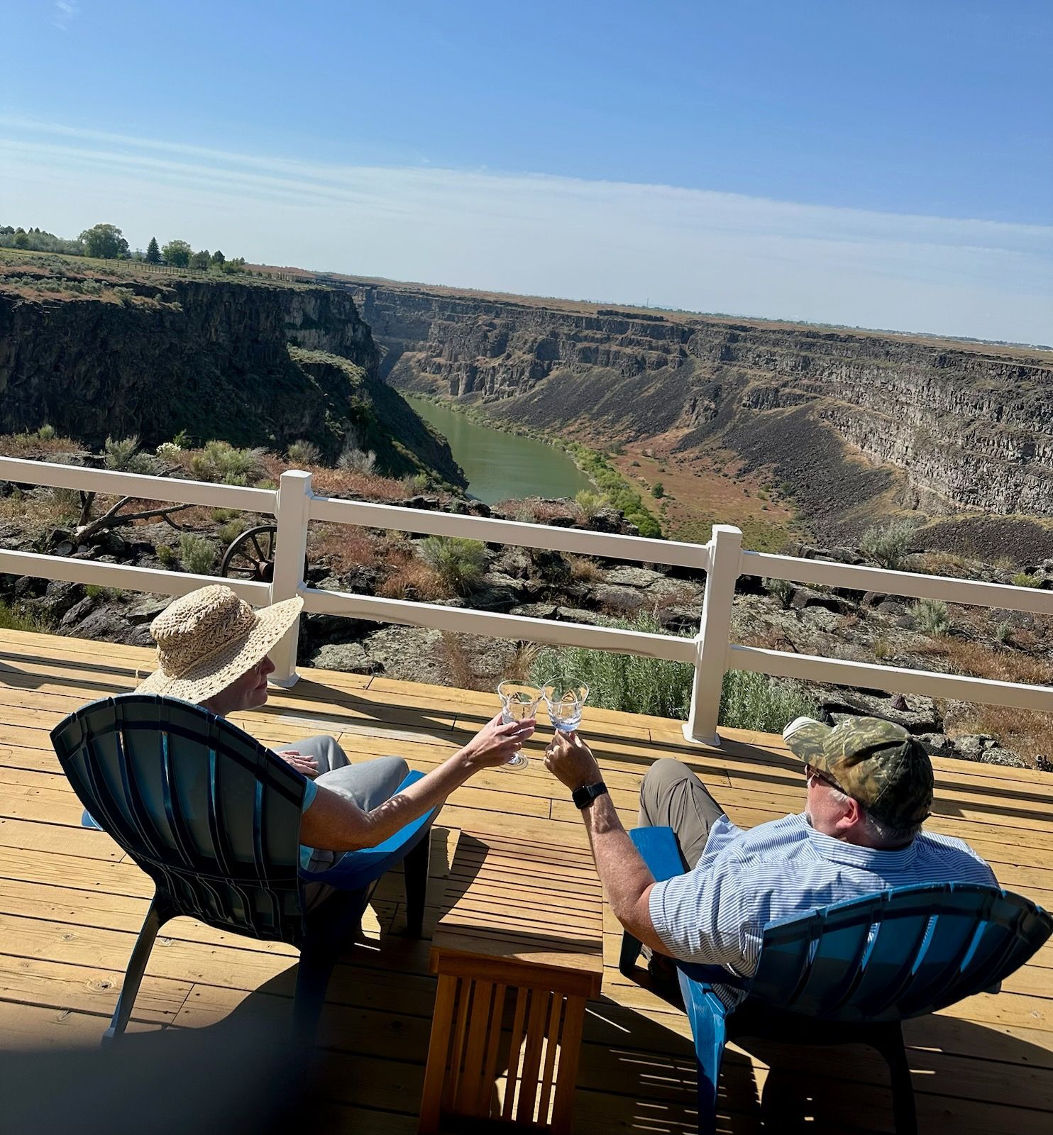 A bedroom with a bed , nightstand , lamp and window.