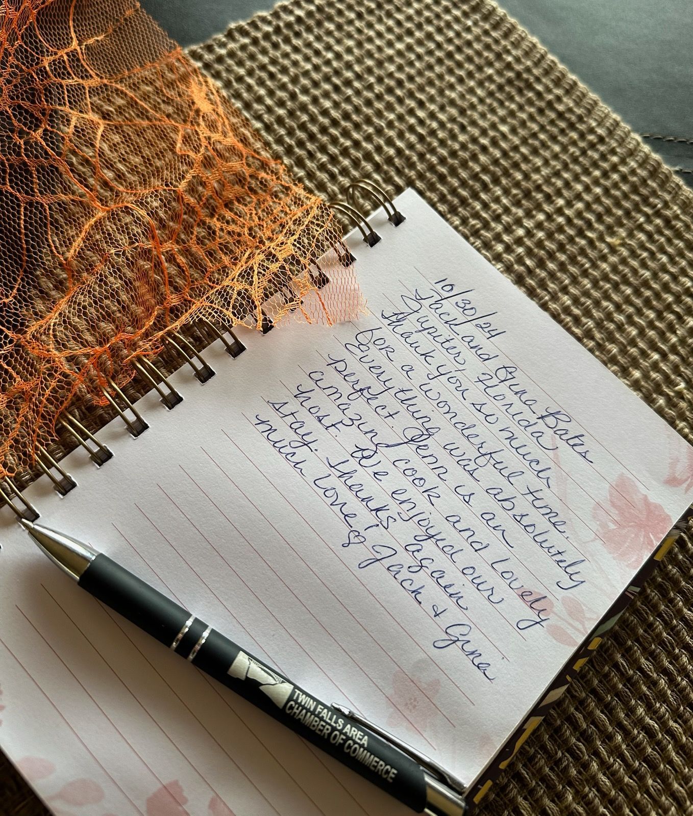 Notebook with handwritten note, pen, and textured surface.