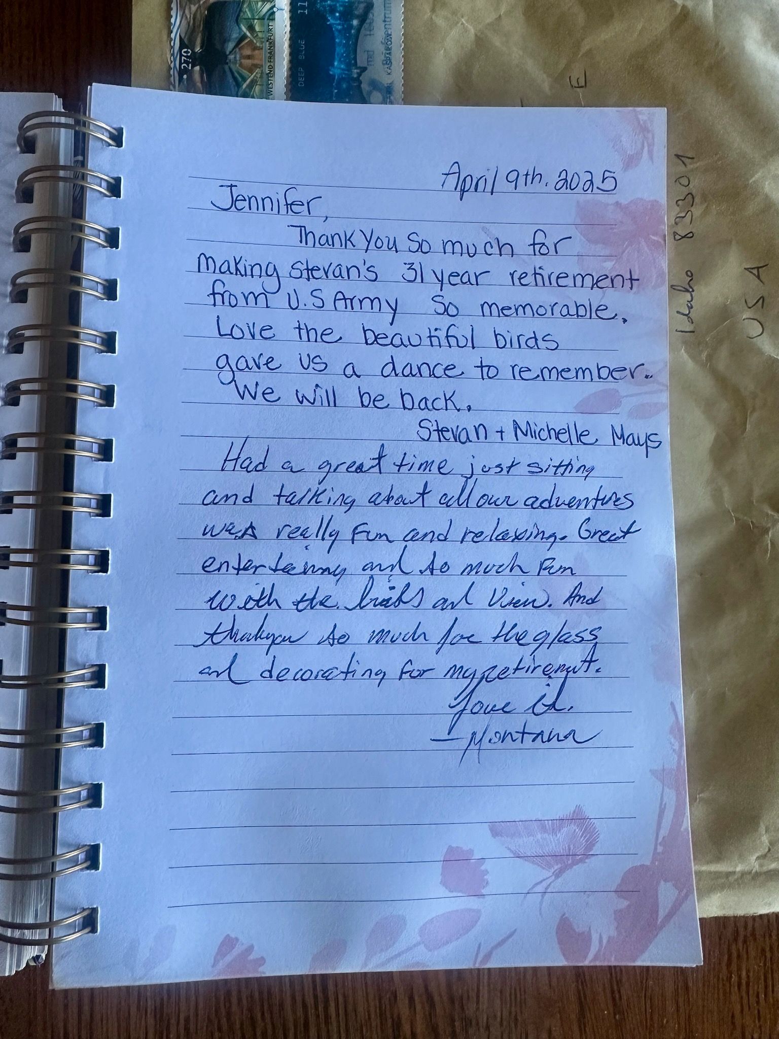 Notebook with handwritten letter on a floral paper, dated April 2015, on a table.