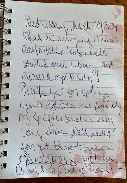 A notebook is open to a page with handwriting on it