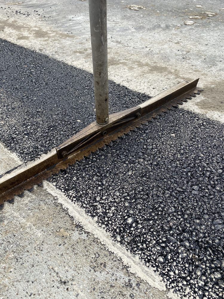 A piece of metal is laying on the ground next to a railroad track.