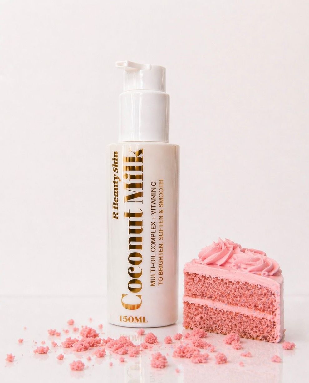 Een wit flesje cosmetische crème naast een roze geglazuurde taart op een lichte achtergrond.