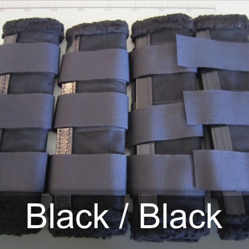 A pair of black / black knee pads on a table