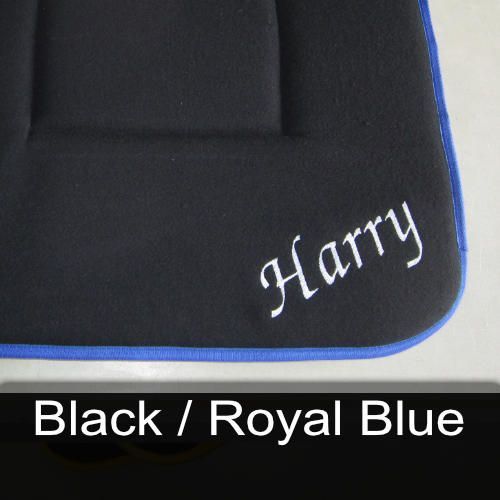 A black cushion with the name harry embroidered on it