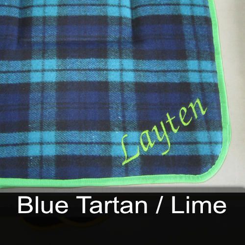 A blue plaid blanket with the name layten embroidered on it