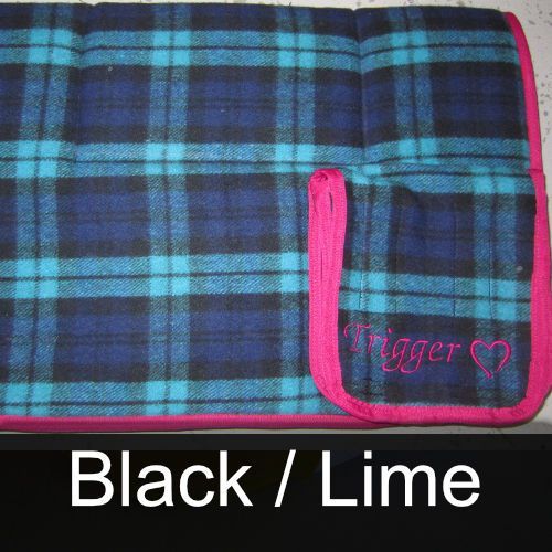 A plaid blanket with the name trigger embroidered on it